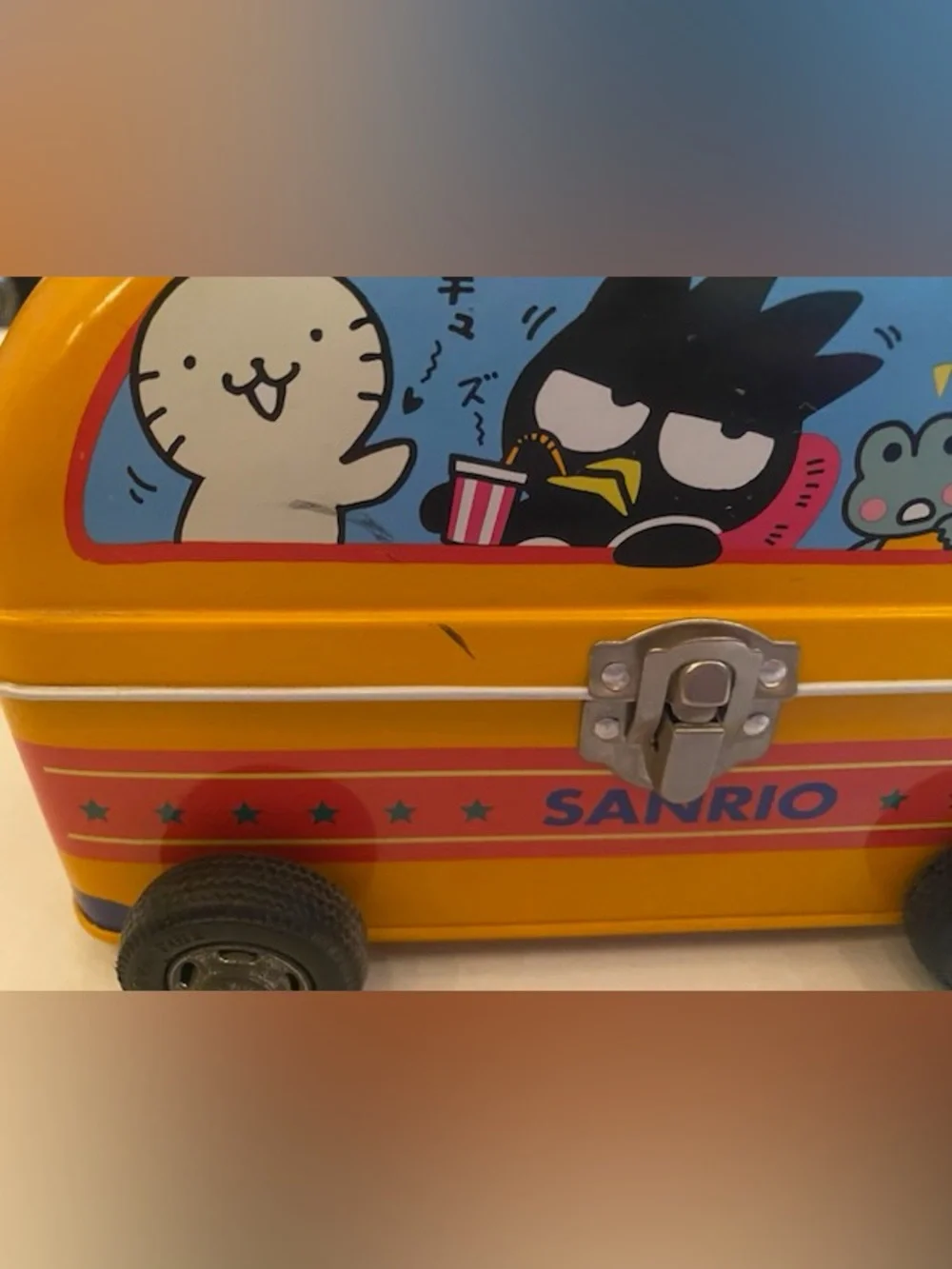 A Sanrio Yellow Toy Bus Metal Carry Case with Teal Handle